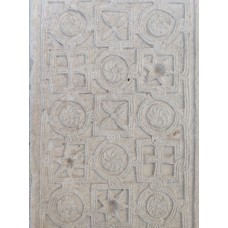 Carved stone panel with repeating pattern of geometric symbo